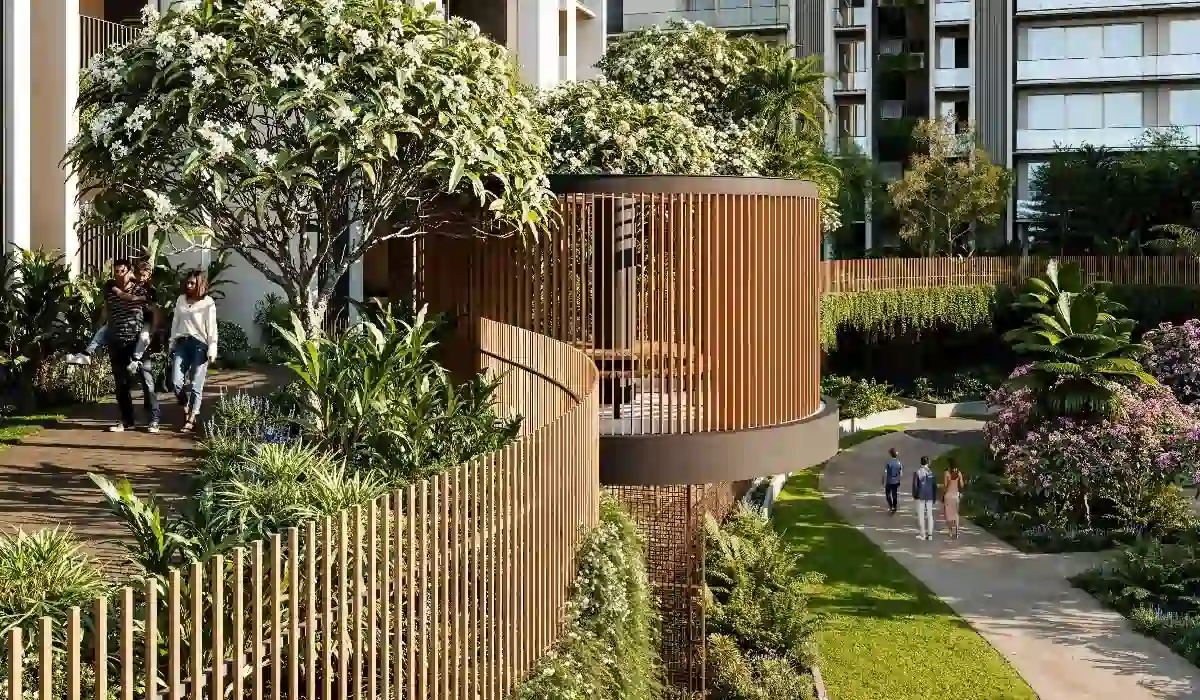 Swimming pool at Conscient Parq, Sector 80, Gurugram, with lounge chairs, greenery, and modern residential buildings around.