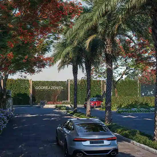 Evening view of Godrej Zenith in Gurgaon with illuminated towers and landscaped gardens.