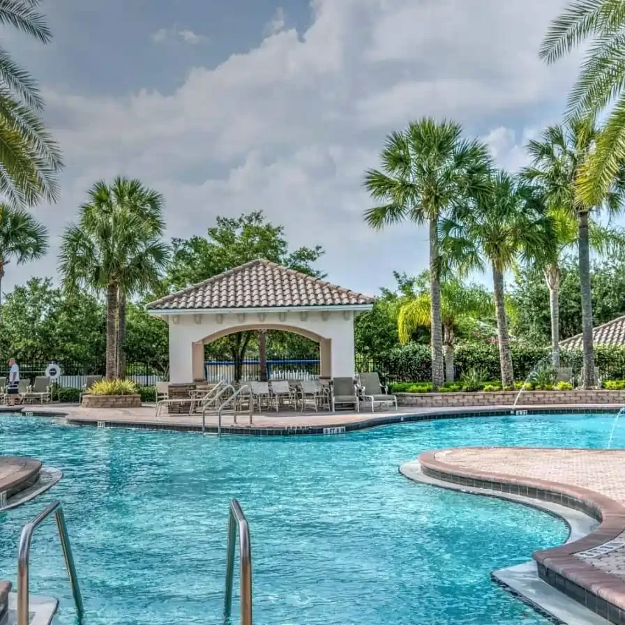 Swimming pool at Vedic City by Ebrix surrounded by landscaped greenery